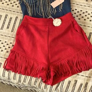 Sued red fringe shorts.